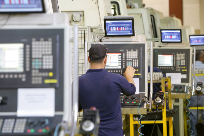 Operator working at a machine on a discrete manufacturing production floor